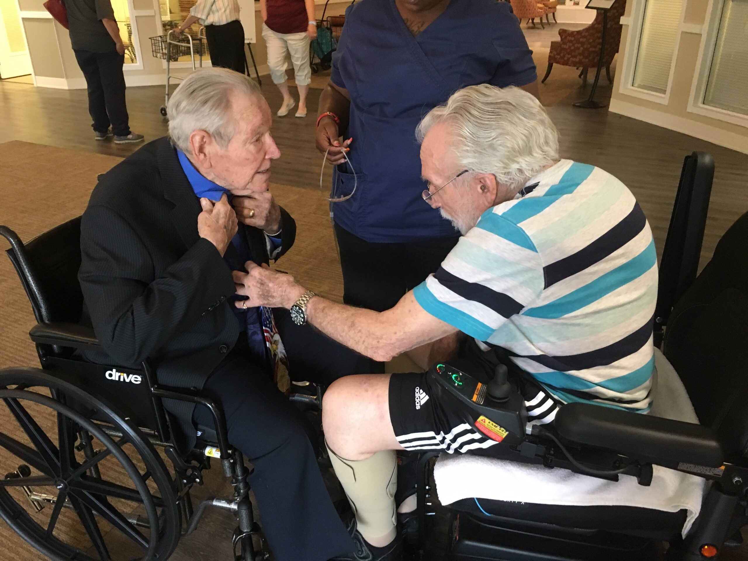 Two Elderly Individuals Sharing a Warm Moment While Seated Indoors